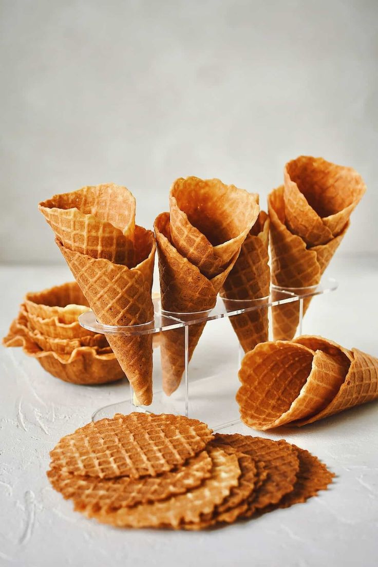 several waffle cones are arranged in small cups