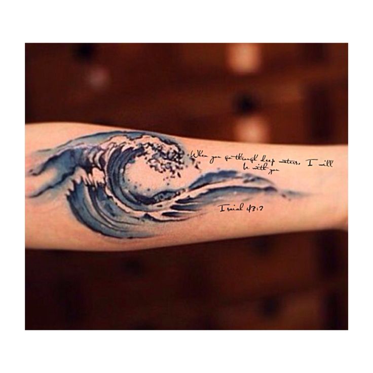 a person with a tattoo on their arm that has an image of a wave in it