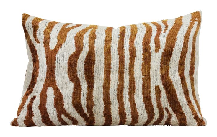 a brown and white striped pillow on a white background with an animal print pattern in the middle