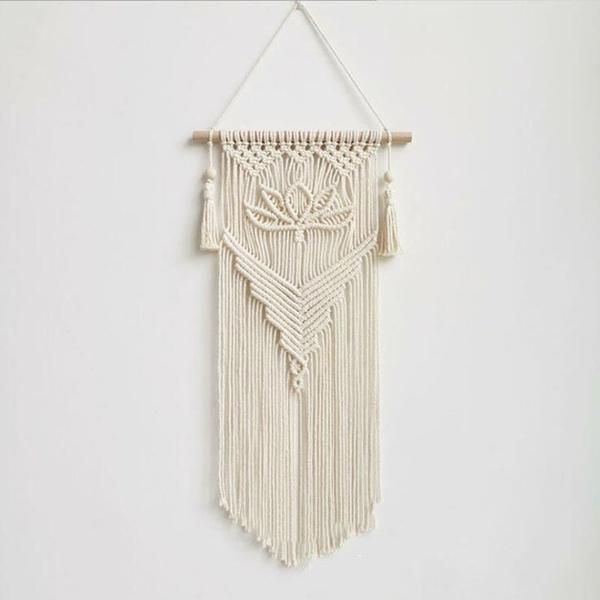 a macrame hanging on a white wall