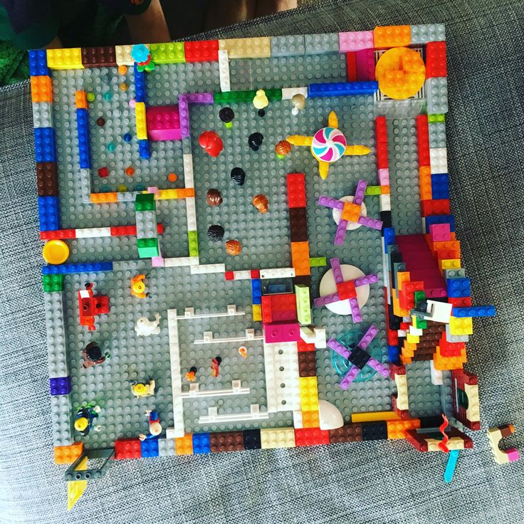 a lego model is shown with many different colored blocks and shapes on the surface, as well as an object that appears to be made out of plastic