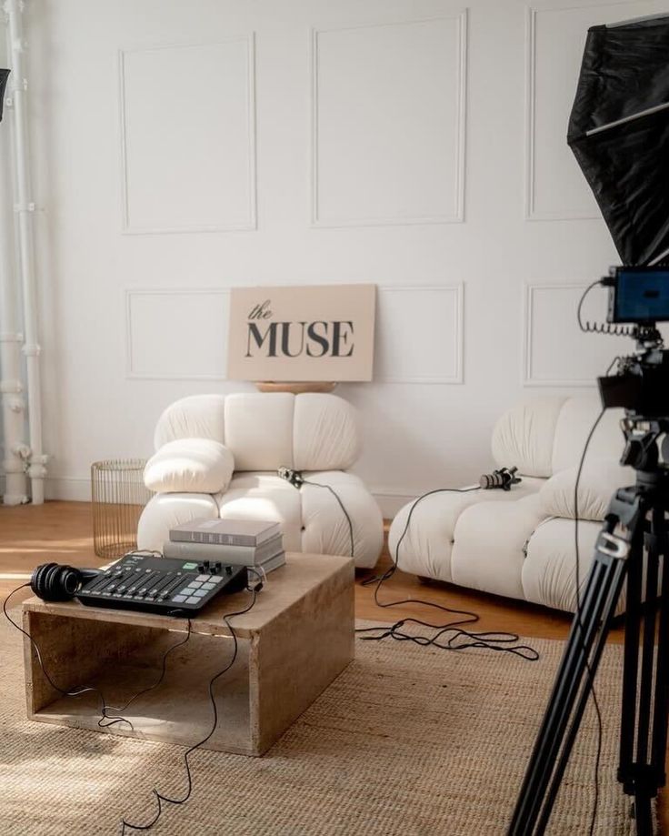 a living room filled with furniture and a projector on top of a coffee table