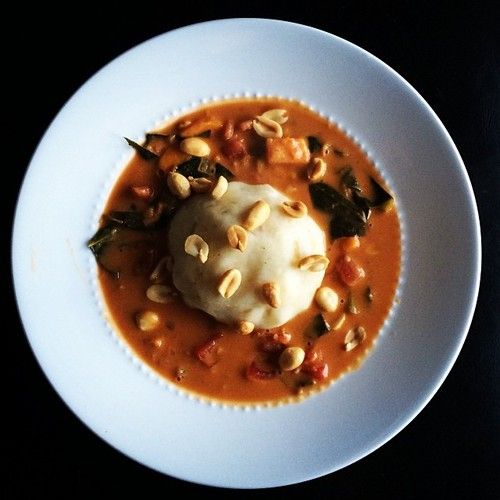 a white plate topped with soup and vegetables