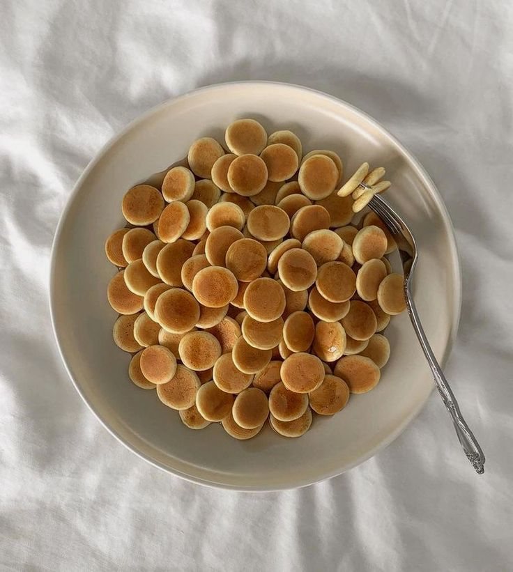 a white plate topped with pancakes and a fork