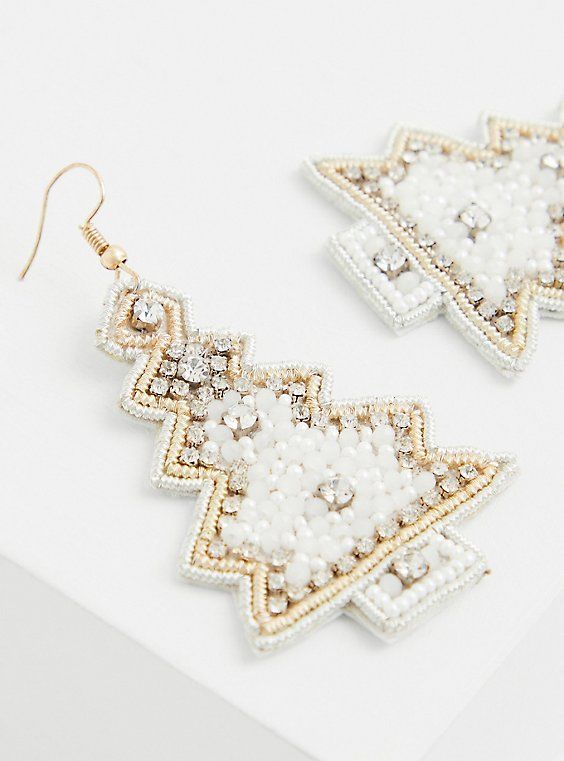 white and gold earrings with beads on top of each earring, sitting on a white surface