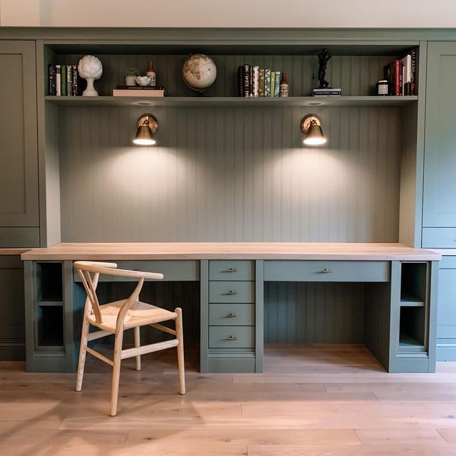 a chair and desk in a room with built - in bookshelves