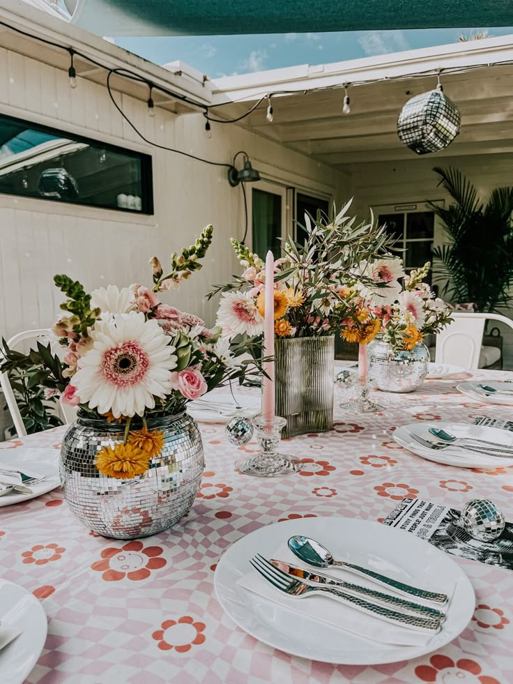 the table is set with flowers and silverware