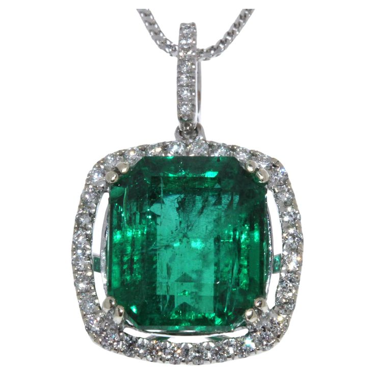 Finish your look with a touch of elegance wearing this gorgeous pendant. One 9.34 carat emerald cut green Emerald takes center stage is surrounded by 39 round brilliant cut diamonds 0.50 carat total weight. The pendant is set in 18K White Gold. This gorgeous pendant is luxurious, rare, and collector worthy. Luxury Gold Emerald Necklace With Square Pendant, Luxury Diamond Cut Emerald Pendant Necklace, Luxury Cubic Zirconia Emerald Pendant Necklace, Luxury Emerald Square Pendant Necklace, Luxury Hallmarked Emerald Pendant Necklace, Diamond Fashion, Emerald Diamond, Emerald Cut, Round Brilliant Cut Diamond