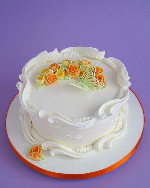 there is a white cake with orange flowers on it