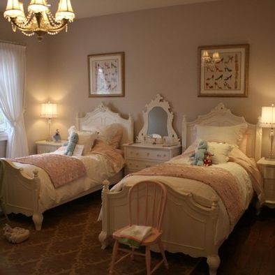 two twin beds in a bedroom with chandelier