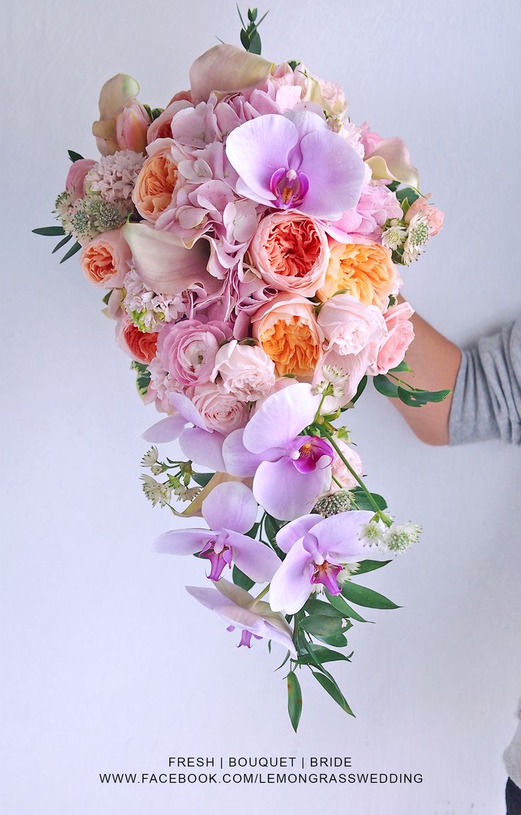 a person holding a bouquet of flowers in their hands