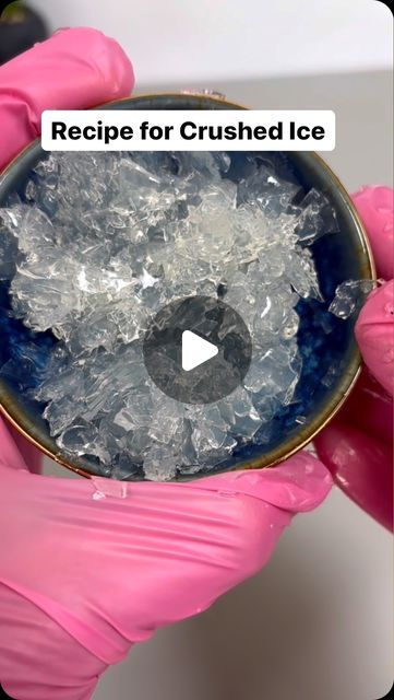 a person in pink gloves holding up a bowl with ice on it and the words recipe for crushed ice