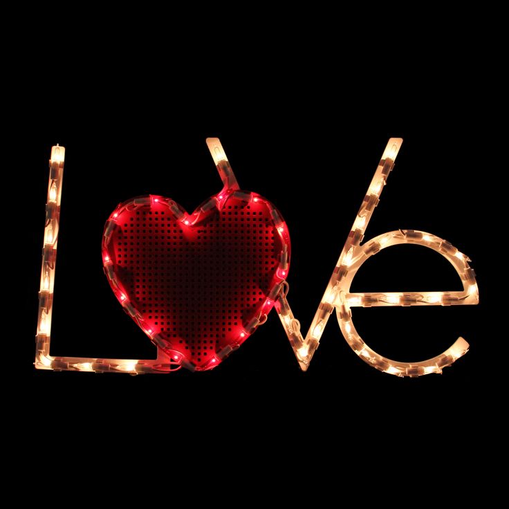 the word love is made up of lights in the shape of a heart on a black background