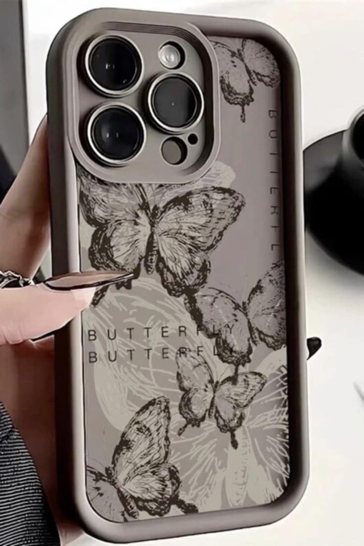 a person holding up an iphone case with butterflies on the front and back cover in grey