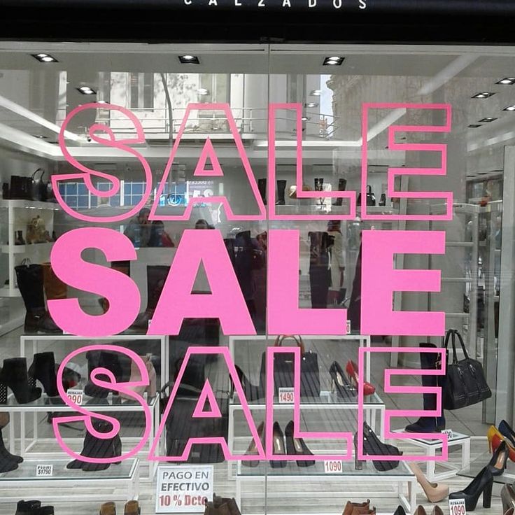 there is a sale sign in the window of a store that sells women's shoes