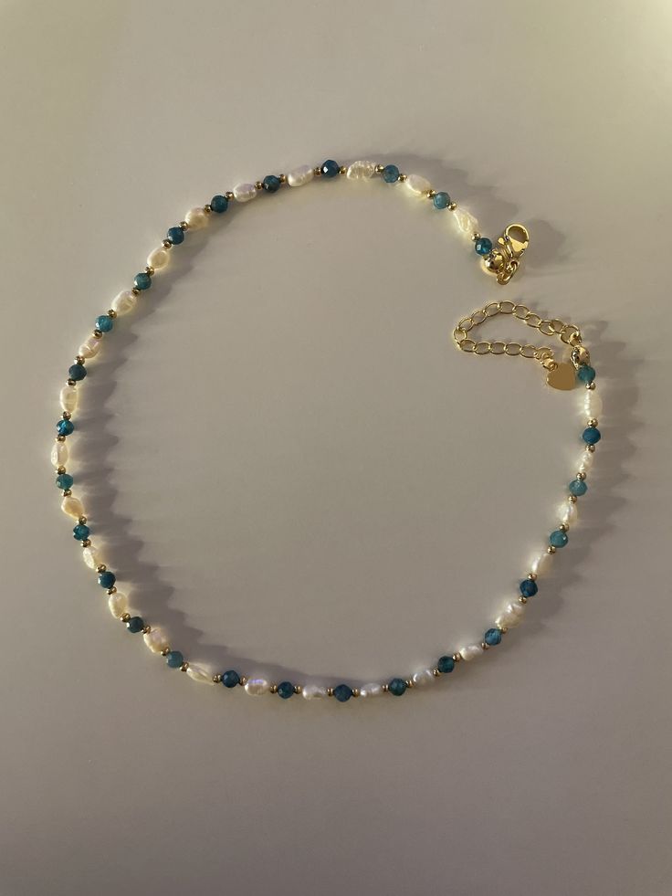 🌟 OUR DELICATE SIREN FRESHWATER PEARL NECKLACE WITH UNIQUE APATITE 🌟 HANDMADE WITH LOVE The small, delicate freshwater pearls are the focus of this elegant necklace, giving it an aura of timeless elegance and grace. The faceted apatite beads set a unique accent and represent self-confidence, communication and inspiration. The gold beads and clasp are plated with 18k gold to ensure durability and elegance. WHY OUR SIREN FRESHWATER PEARL NECKLACE WITH APATITE? ✨ Unique design of the highest qual Cheap Beaded Pearl Necklace For Beach, Beads Necklace Design, Handmade Necklace Designs, Small Pearl Necklace, Handmade Gold Necklace, Handmade Pearl Necklace, Golden Beads, Pearl Jewelry Design, Pearl Necklace Designs