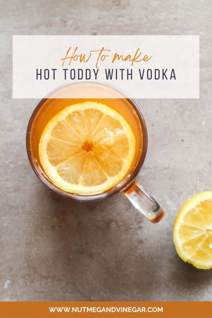 a cup of hot toddy with vodka and sliced lemons on the side text overlay reads how to make hot toddy with vodka