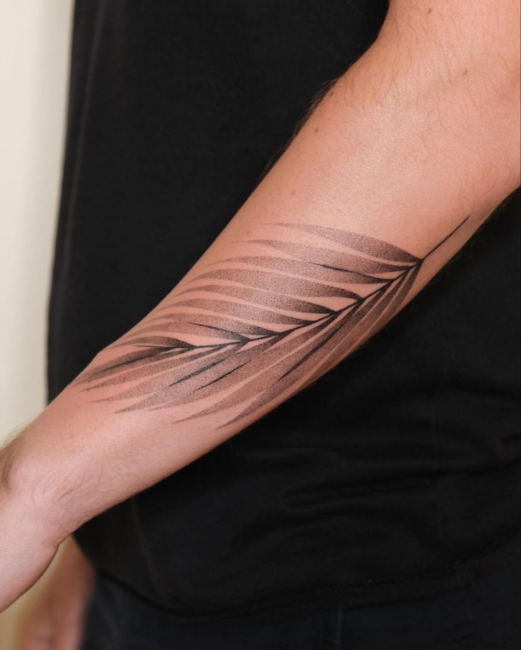 a man's arm with a tattoo on it that has an arrow in the middle