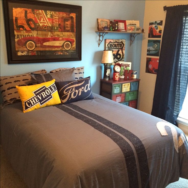 a bed room with a neatly made bed next to a window and a painting on the wall