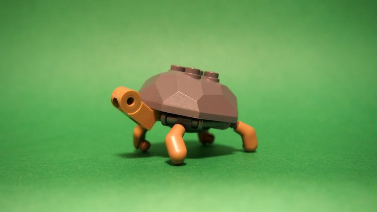 a small toy turtle on a green surface