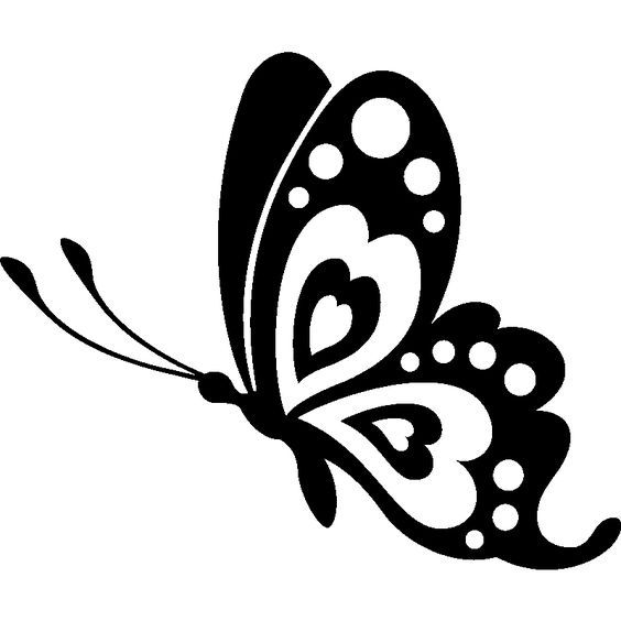 a black and white butterfly with dots on it's wings, flying in the air