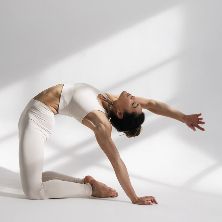 a woman in white is doing yoga poses