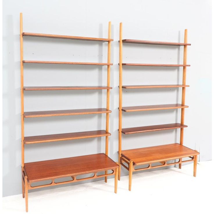 two wooden shelving units with benches on each shelf