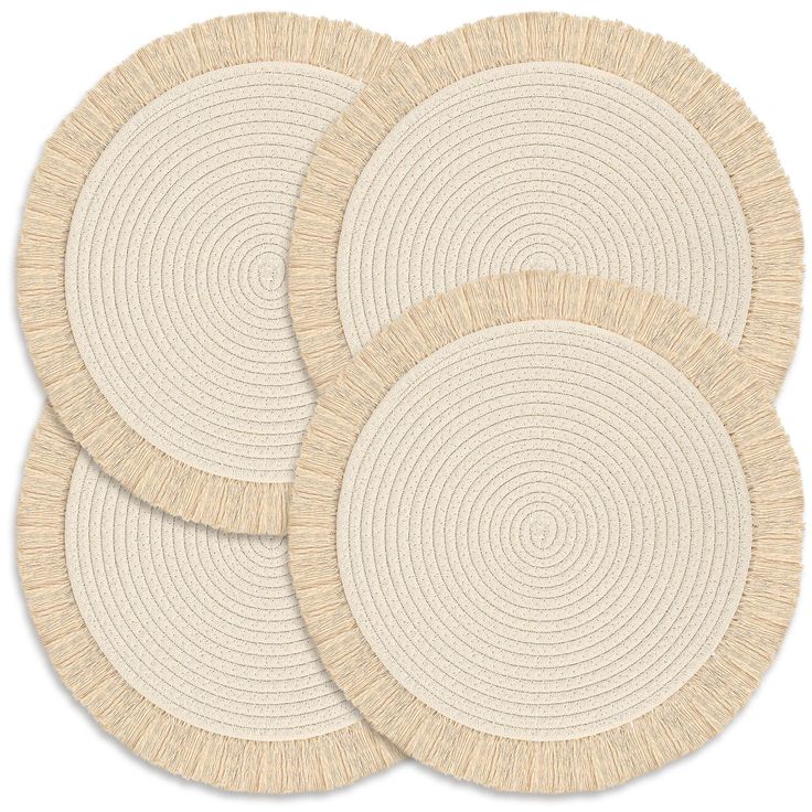 three round placemats in beige and white with circular designs on the top, set of