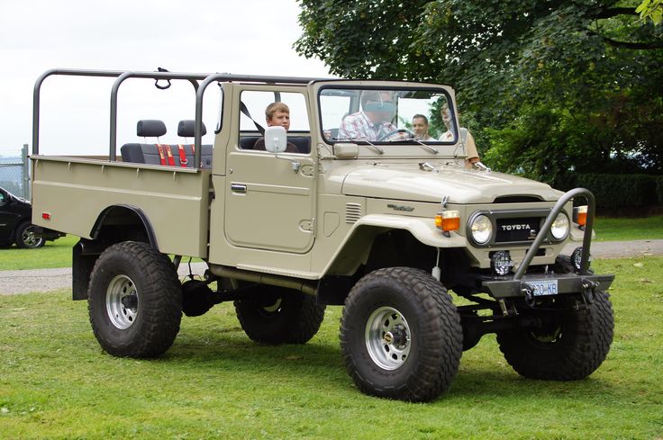 two men are in the back of an off - road jeep