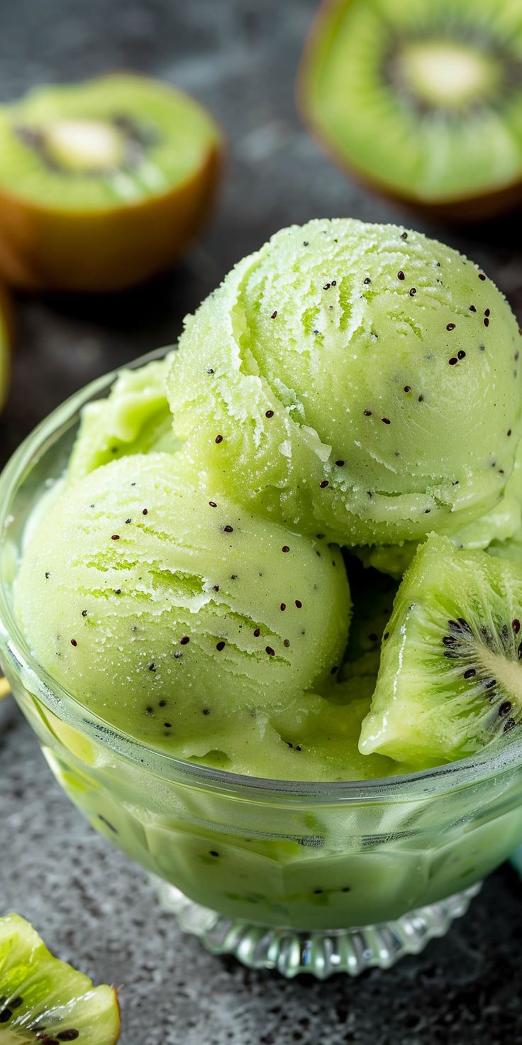 kiwi ice cream in a glass bowl with sliced kiwis