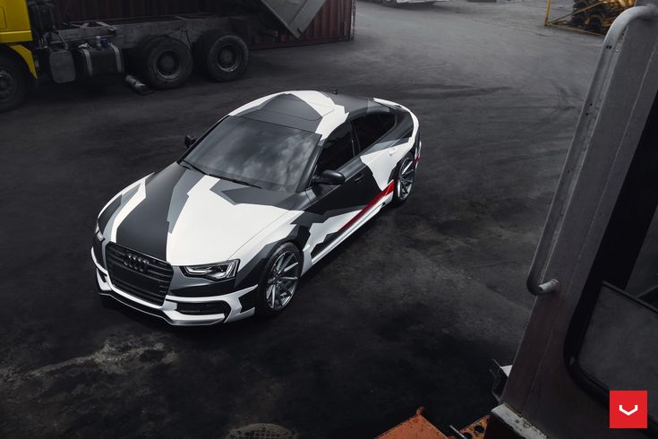 a white and black car parked in a parking lot