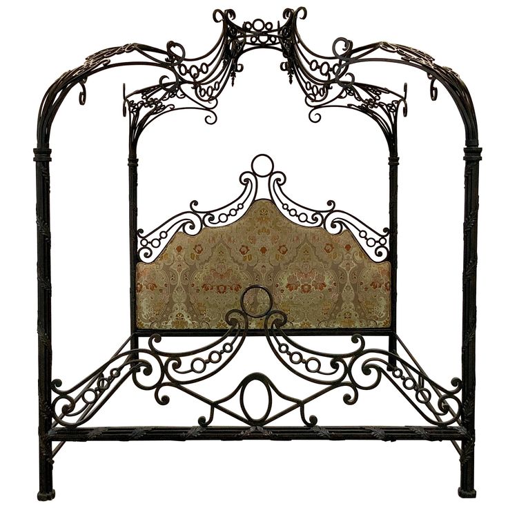 a wrought iron bed frame with an intricate design