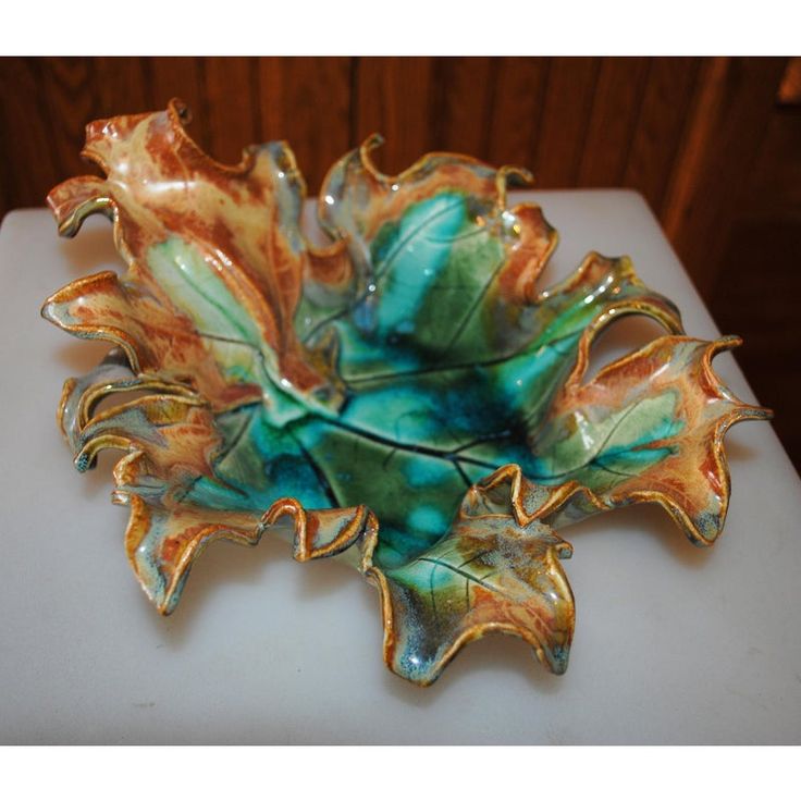 a decorative glass bowl sitting on top of a table