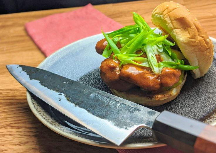 a plate with a sandwich and knife on it