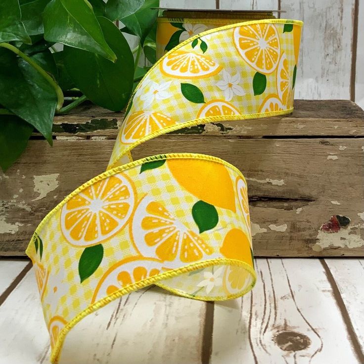 two yellow and white lemons on gingham ribbon