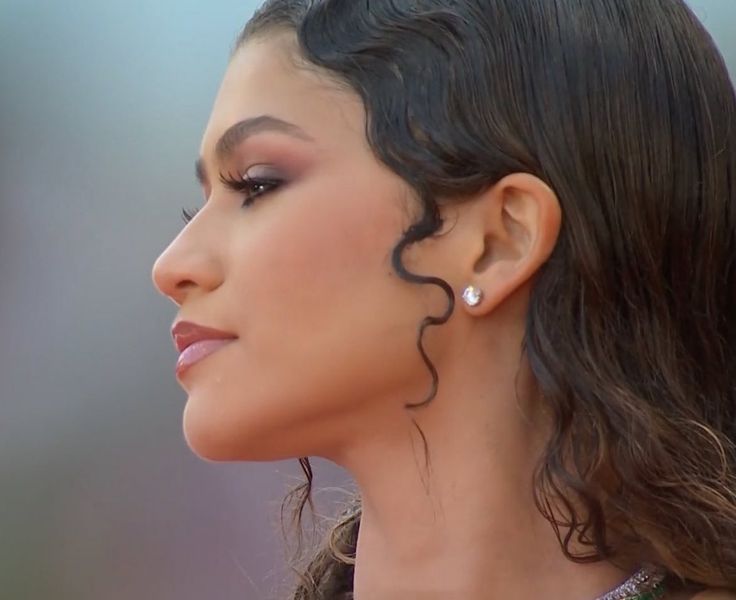 a close up of a person wearing earrings