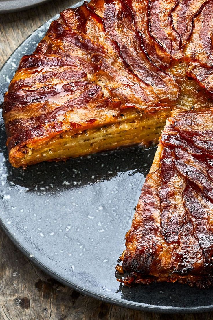 a large piece of meat on a plate with one slice cut out and ready to be eaten