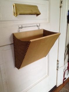 the door is open and there is a paper boat hanging from it's side