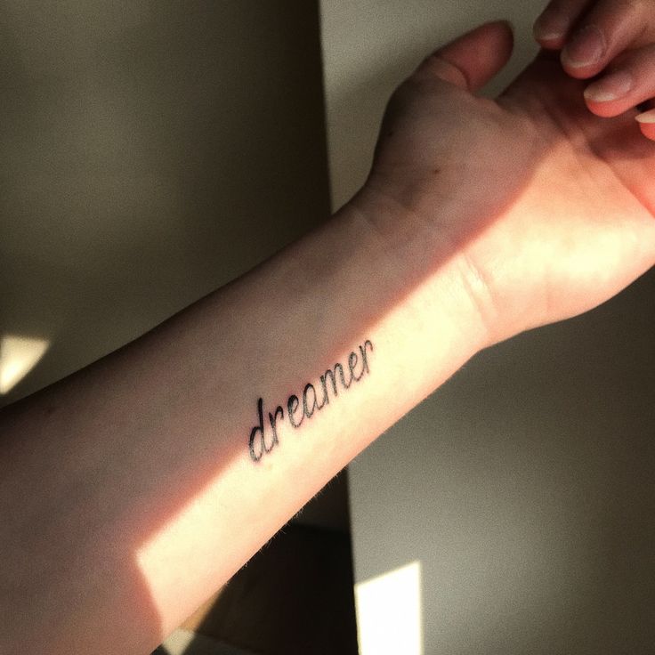 a person's arm with the word dracour written on it in cursive font