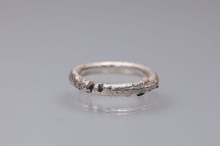 An unusual sterling silver ring band cast in beach sand which has left some grains into the silver; like a finger print, making this ring truly unique.  It is totally handcrafted by me in my atelier NYAMI  in Italy, with the ancient sand casting method, where molten sterling silver is poured into the ring mould made with the sand.   In this case  the sand is  from the village where I leave near to the Cinque Terre, which gave the ring the organic texture on the surface and left some tiny grain o Cast Rings, Dainty Jewellery, Capsule Closet, Sand Textures, Ring Making, Finger Print, Grain Of Sand, Sand Casting, Sterling Silver Rings Bands