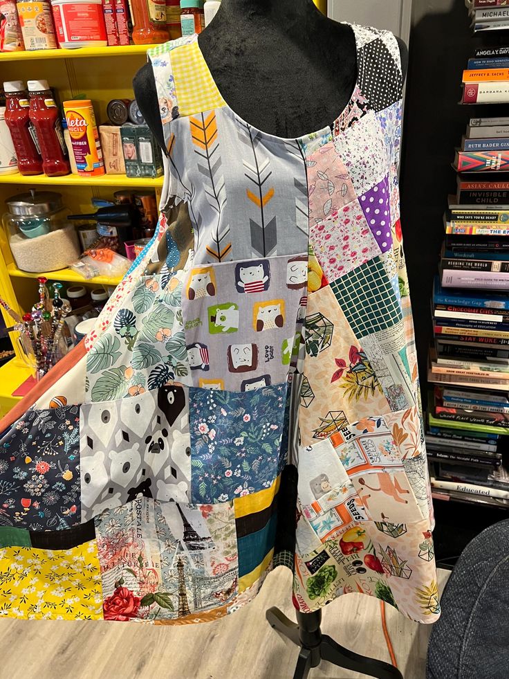 a dress made out of patchwork fabric on a mannequin in a store