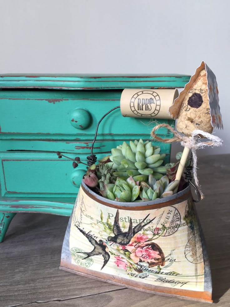 a potted plant with succulents in it sitting on a wooden table