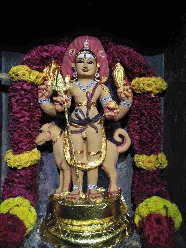 the statue is decorated with flowers and gold