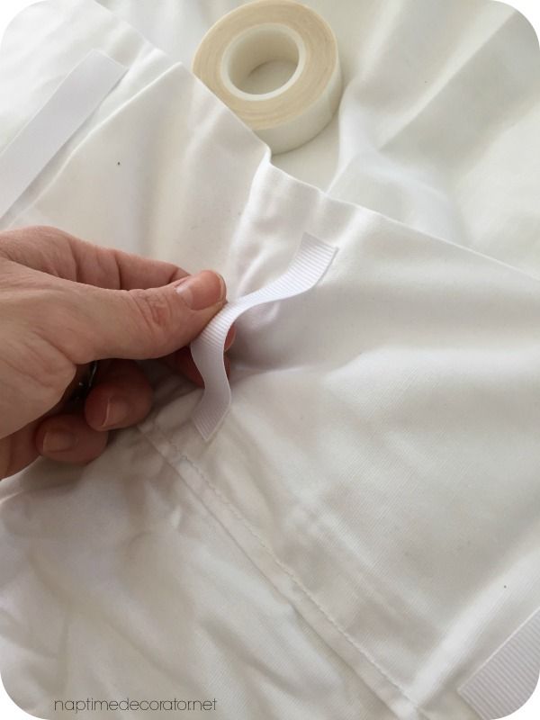 someone is cutting through the white fabric with scissors