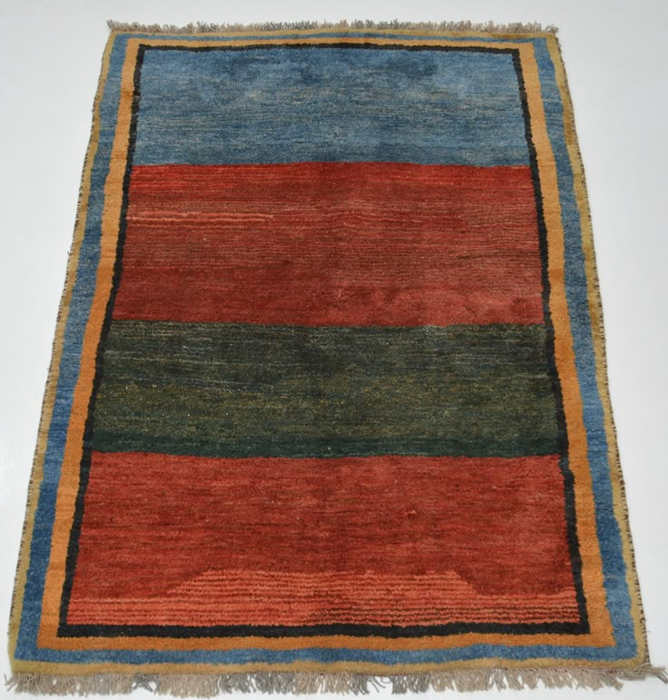 a multicolored rug with fringes on the bottom