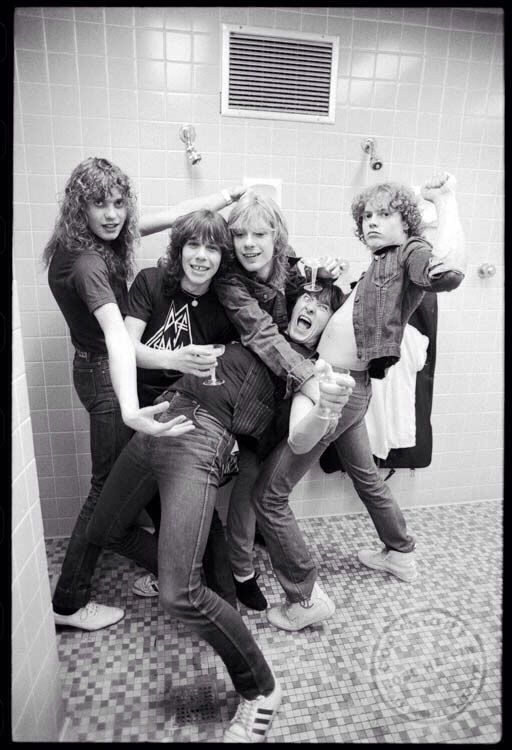 four women in a bathroom posing for the camera