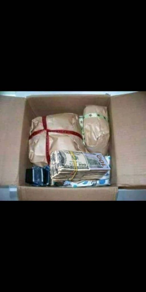 an open cardboard box filled with money and wrapped in wrapping