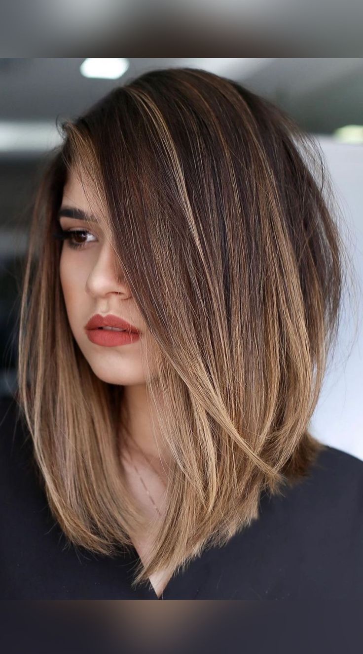 a woman with brown hair and red lipstick is looking off to the side while wearing a black shirt