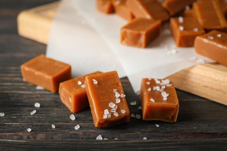 several pieces of chocolate sitting on top of a cutting board