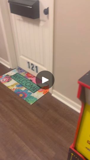 a doormat that is on the ground in front of a door with a mailbox